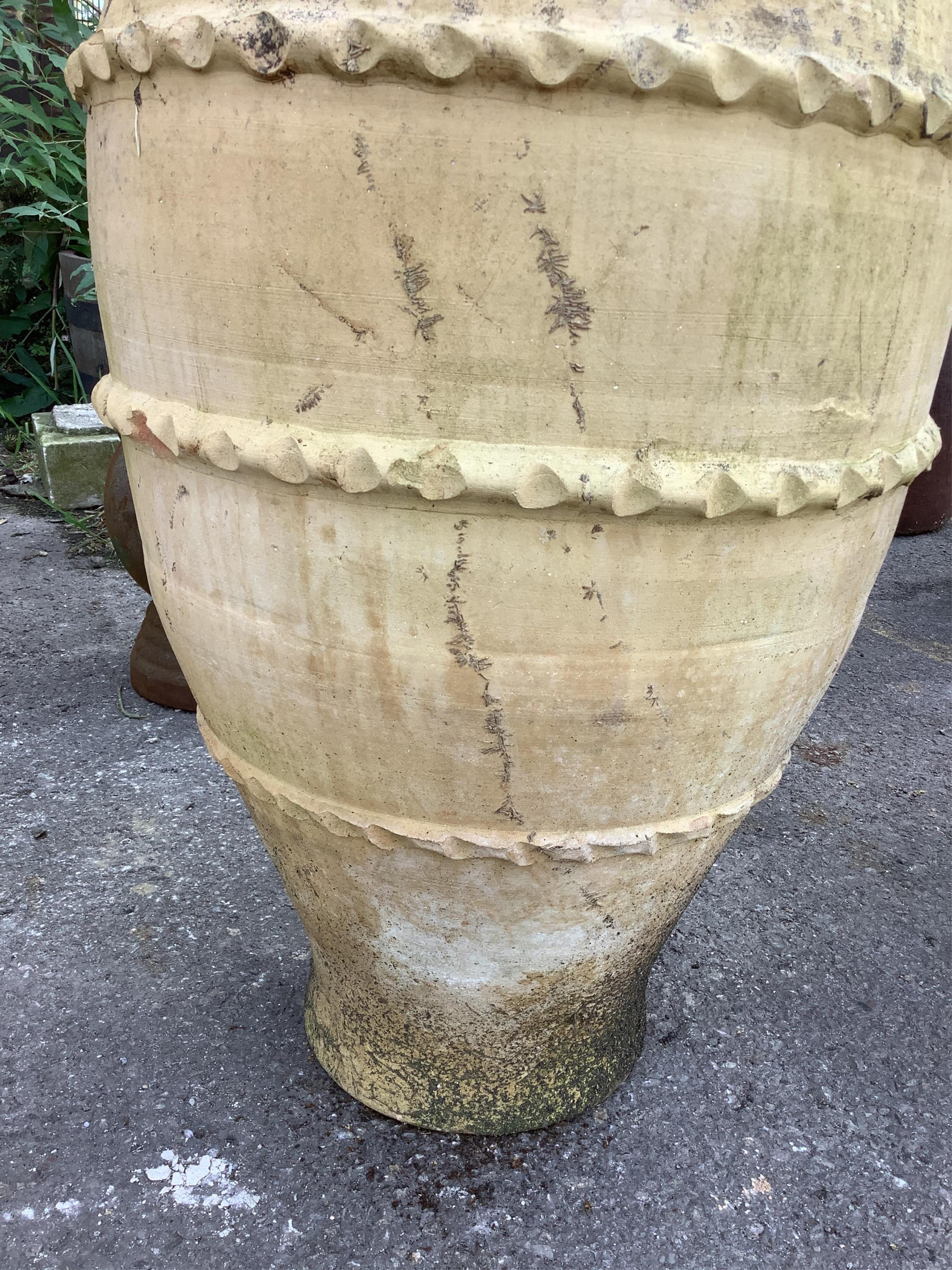 A pair of terracotta amphora style garden urns, height 68cm. Condition - weathered and one cracked